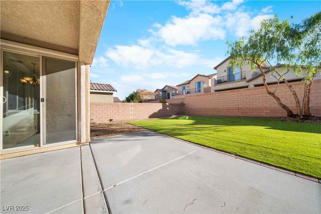 10059 Lady Apple Drive Las Vegas, NV 89148 - Photo 27 of 31 Fenced backyard featuring a residential view and a patio area