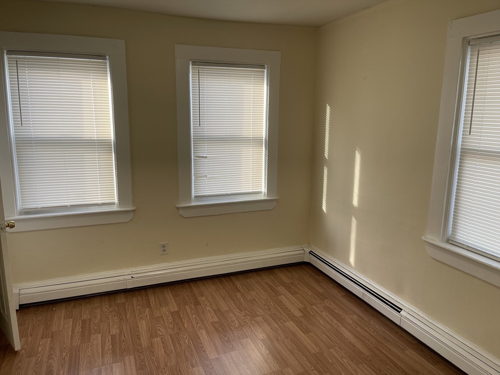 5 Albemarle Street, Unit 3 Boston, MA 02136 - Photo 7 of 8 an empty room with wooden floor and windows