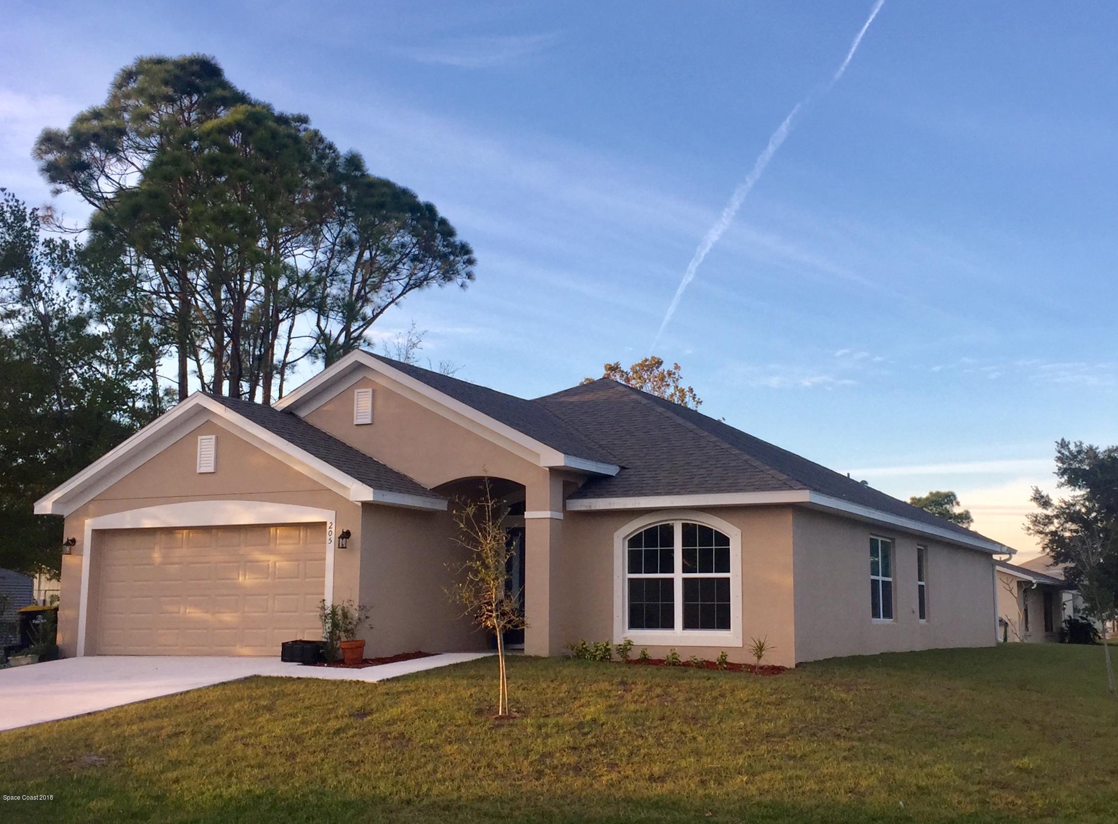 1168 Hathaway Road Southwest Palm Bay, FL 32908 - Photo 1 of 9 a front view of a house with a yard