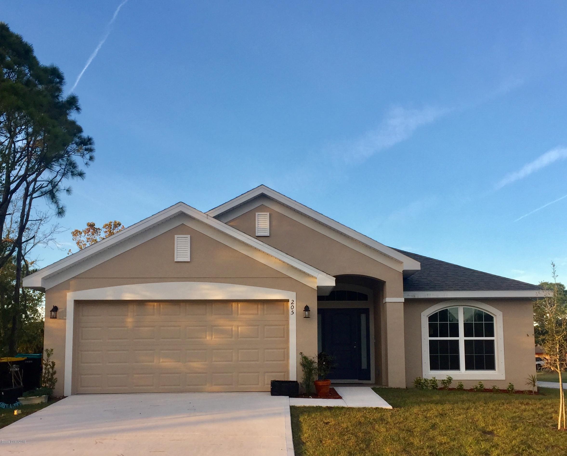 1168 Hathaway Road Southwest Palm Bay, FL 32908 - Photo 2 of 9 a front view of a house with a yard