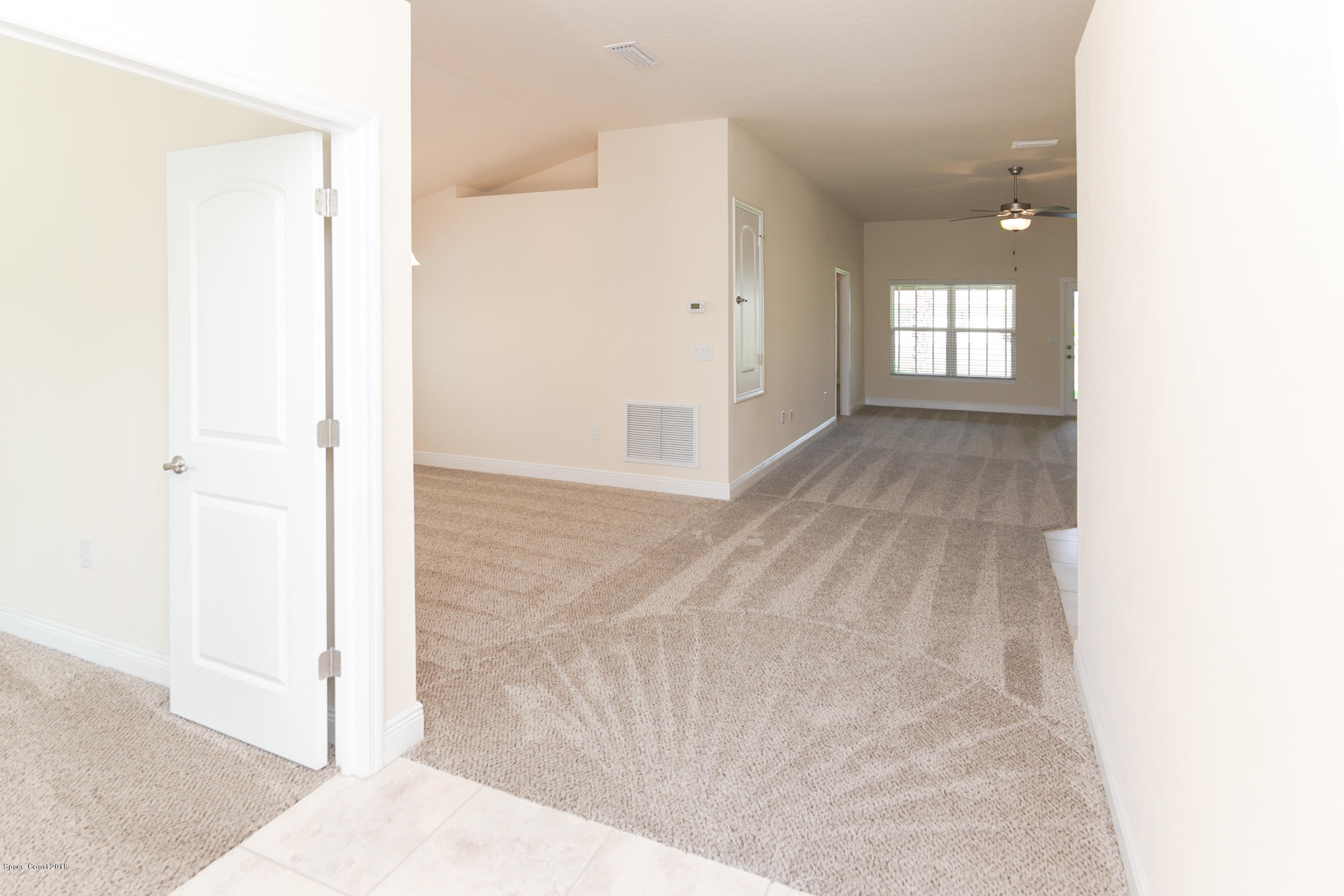 1168 Hathaway Road Southwest Palm Bay, FL 32908 - Photo 3 of 9 a view of a hallway with bathroom and a window