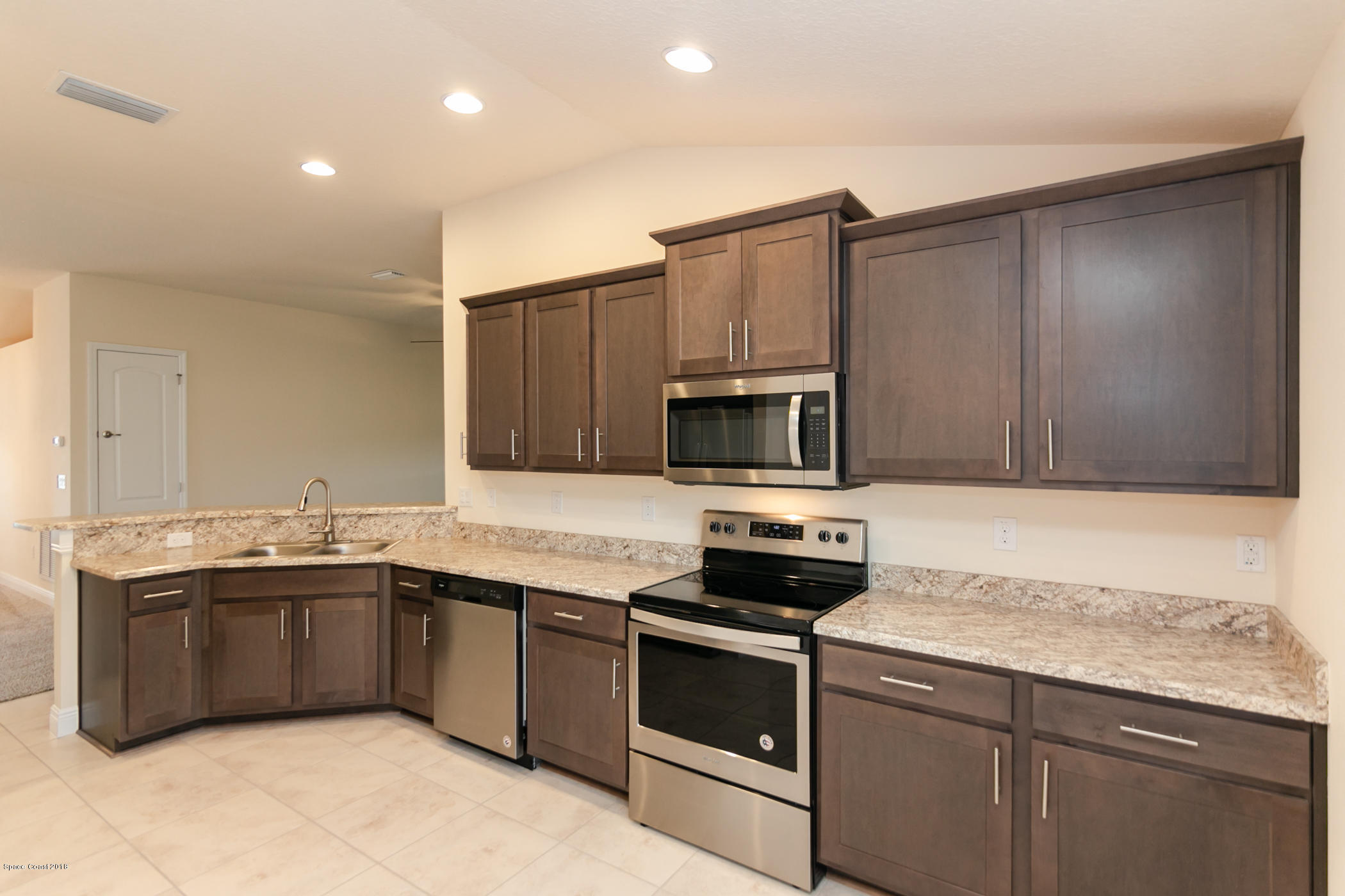 1168 Hathaway Road Southwest Palm Bay, FL 32908 - Photo 5 of 9 a kitchen that has a sink and a stove in it