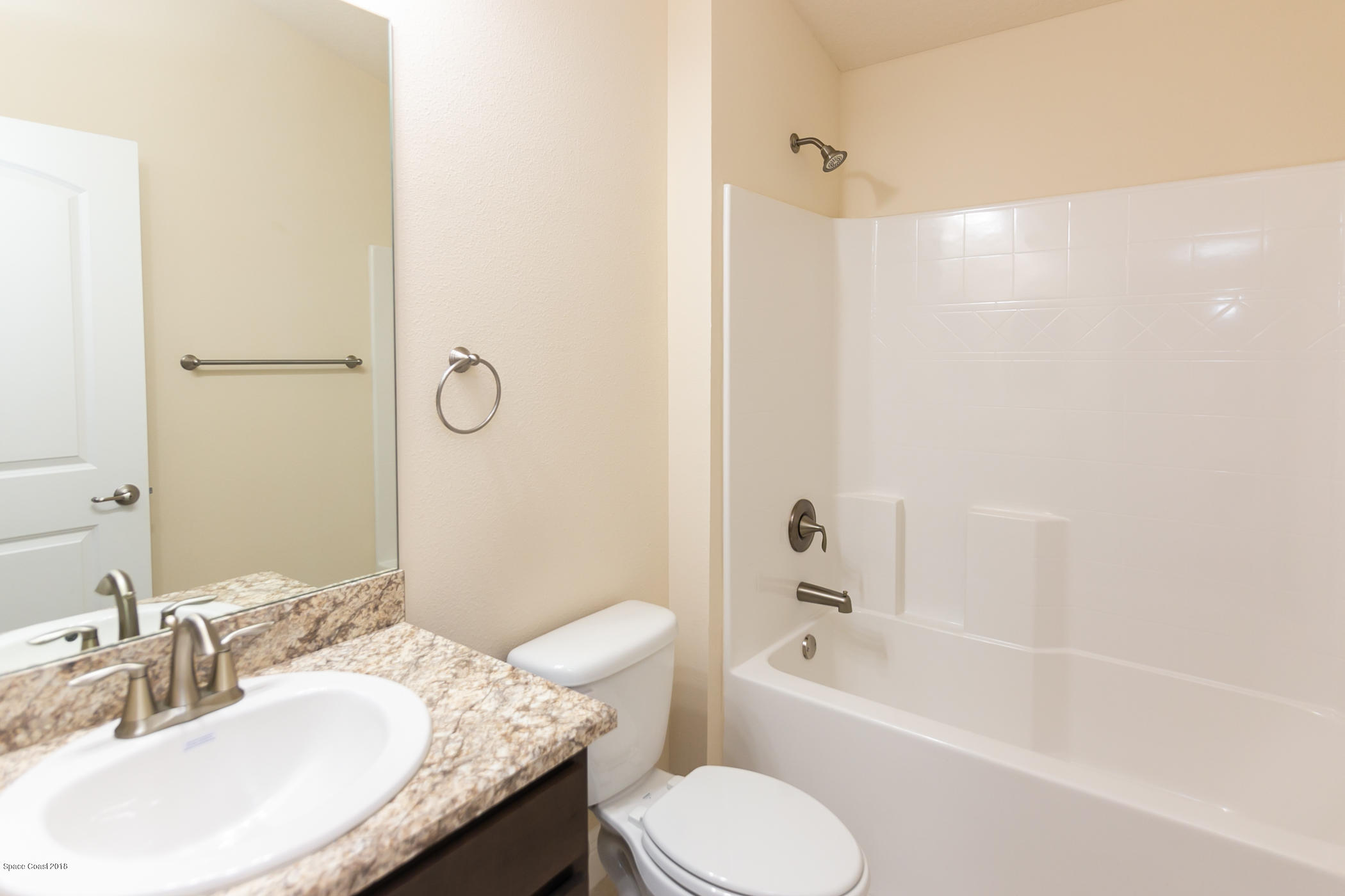 1168 Hathaway Road Southwest Palm Bay, FL 32908 - Photo 8 of 9 a bathroom with a granite countertop sink toilet and shower