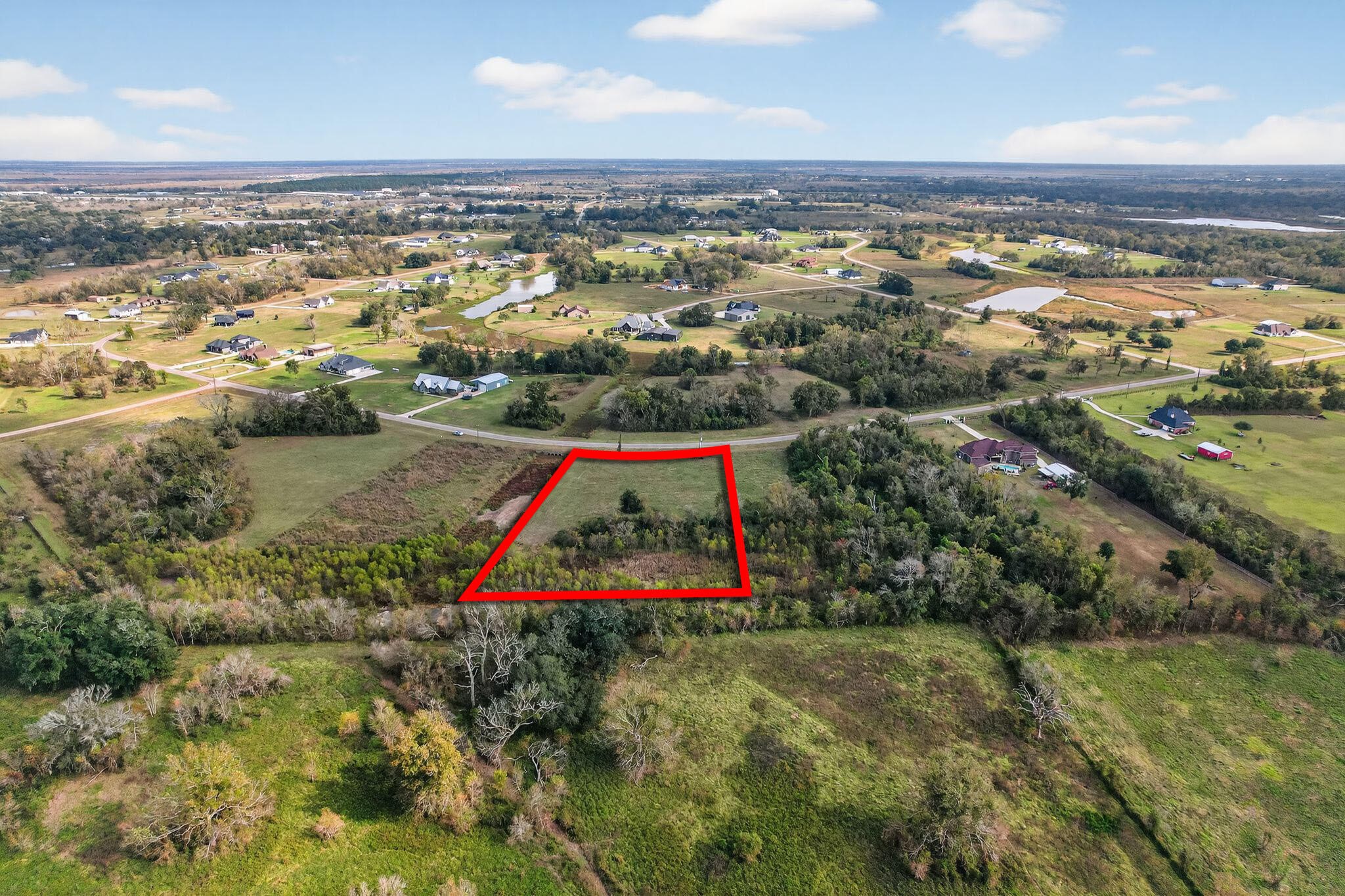 an aerial view of residential houses with outdoor space and swimming pool