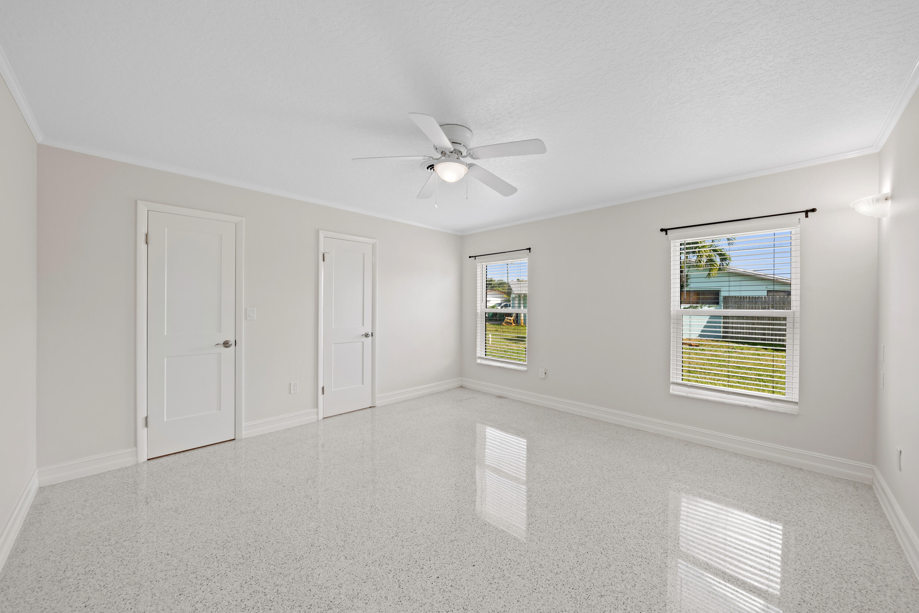 415 Rosedale Drive Satellite Beach, FL 32937 - Photo 11 of 52 an empty room with windows and ceiling fan