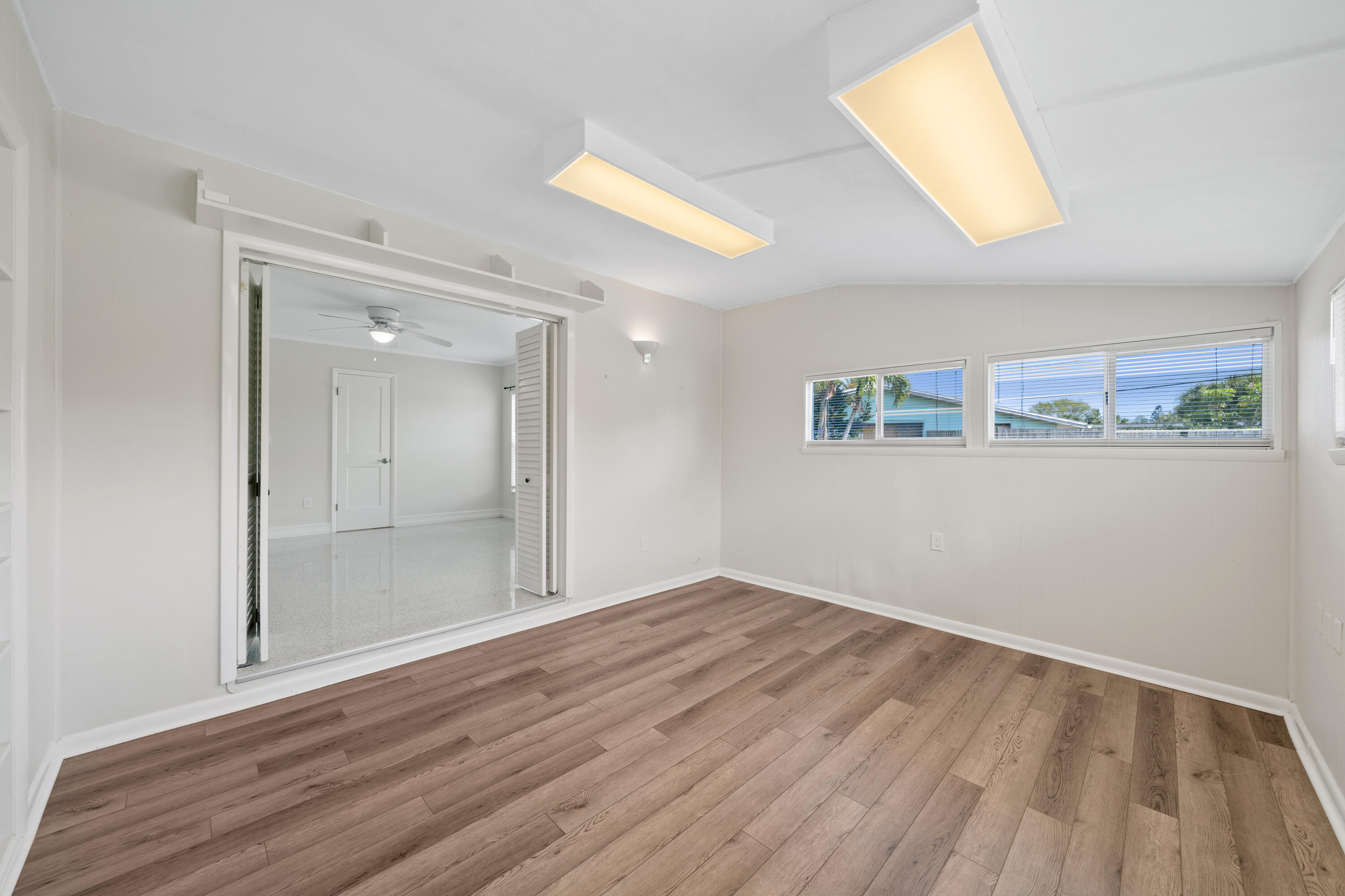 415 Rosedale Drive Satellite Beach, FL 32937 - Photo 15 of 52 wooden floor in an empty room with a window