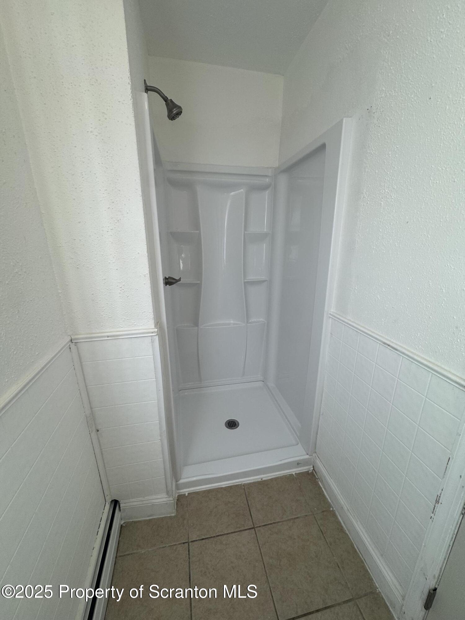 1135 Lloyd Street, Unit 2 Scranton, PA 18508 - Photo 12 of 18 a bathroom with a glass shower door