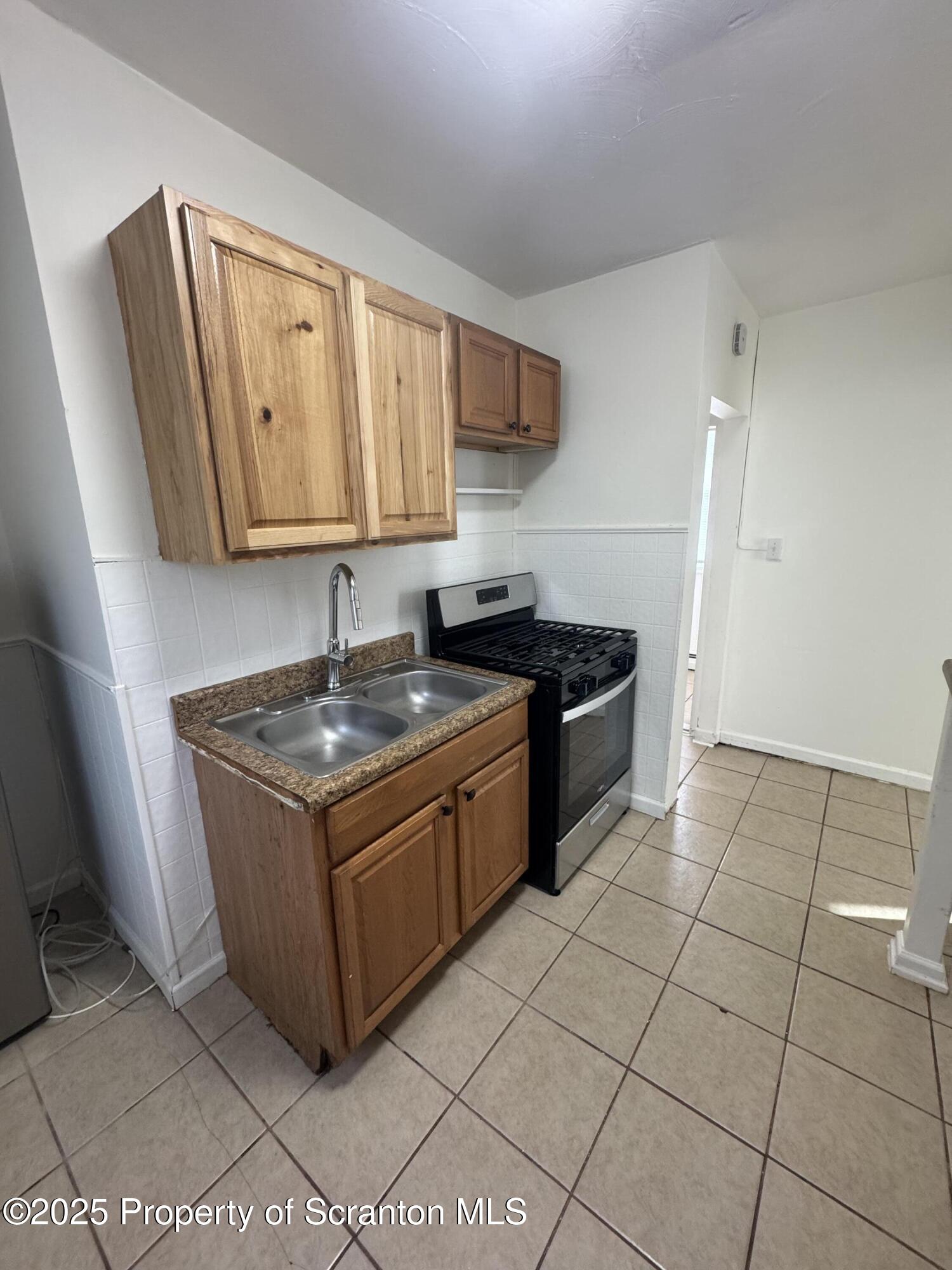 1135 Lloyd Street, Unit 2 Scranton, PA 18508 - Photo 13 of 18 a kitchen with granite countertop a sink and a stove
