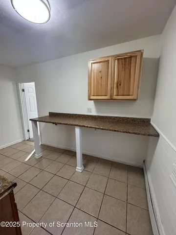 a living room with a wooden floor and a table