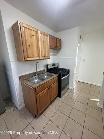 a kitchen with granite countertop a sink and a stove
