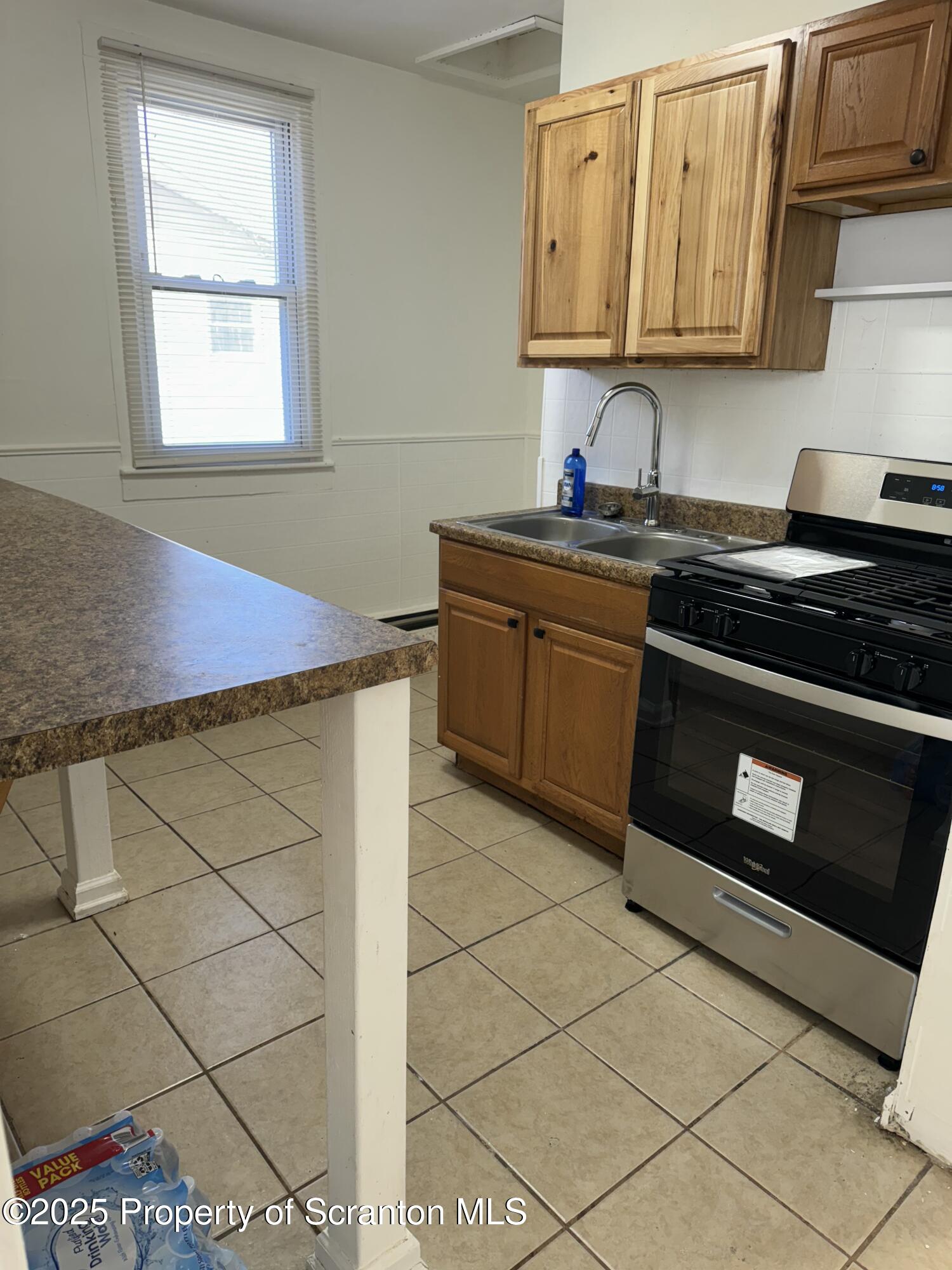 1135 Lloyd Street, Unit 2 Scranton, PA 18508 - Photo 2 of 21 a kitchen with stainless steel appliances granite countertop a sink and a stove