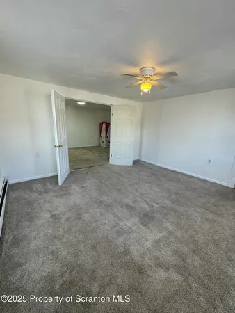 an empty room with closet and chandelier fan