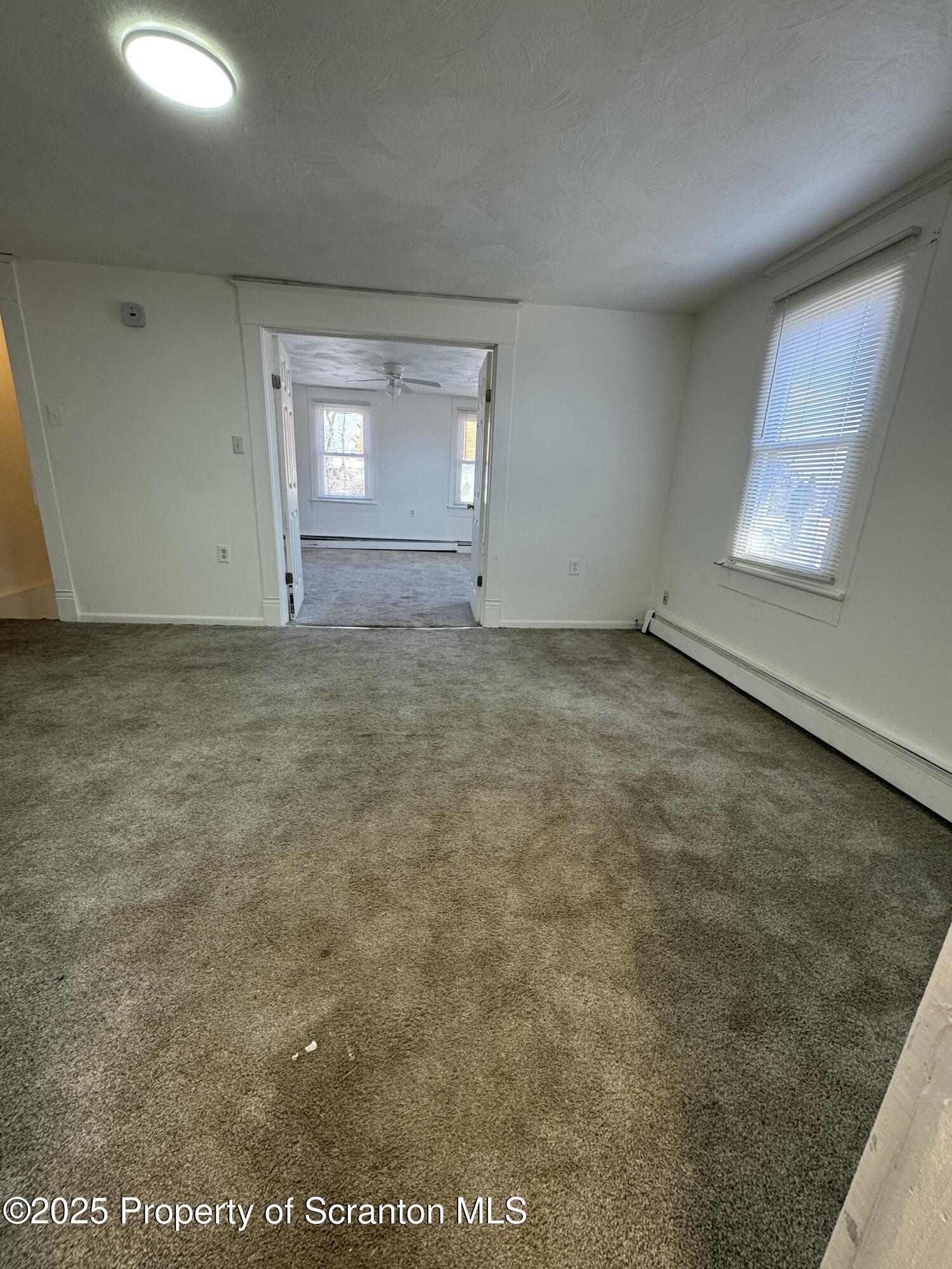 1135 Lloyd Street, Unit 2 Scranton, PA 18508 - Photo 7 of 18 an empty room with a empty space and windows