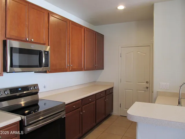a kitchen with a sink cabinets and stainless steel appliances
