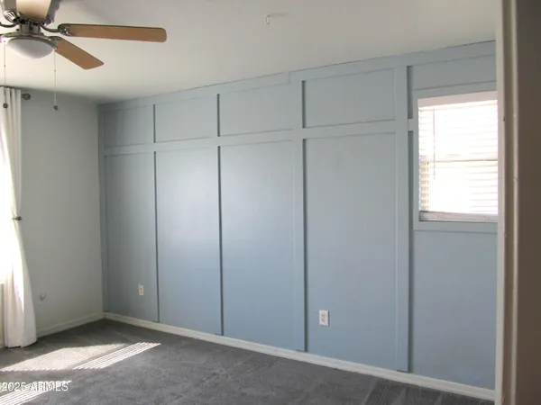 a view of empty room with ceiling fan