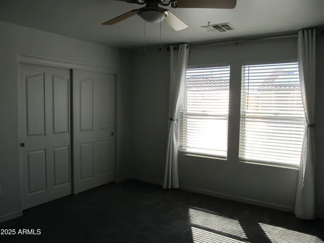 a bathroom with a granite countertop bathtub shower sink vanity and toilet