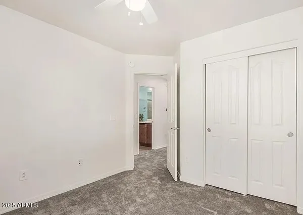 an empty room with windows and closet