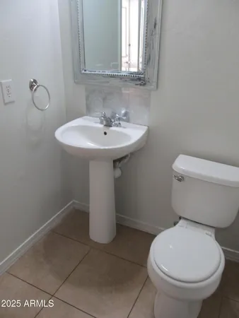 a white toilet sitting next to a bathroom sink