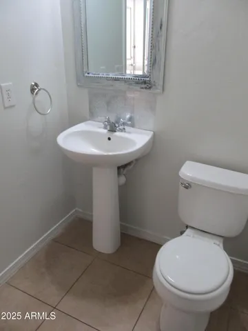 a white toilet sitting next to a bathroom sink