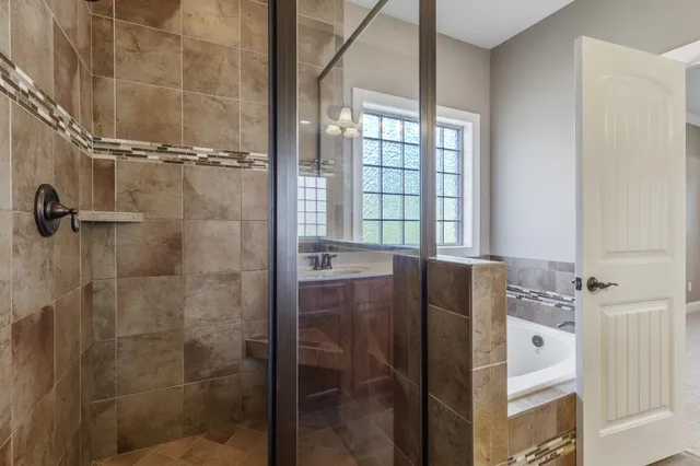 a bathroom with a bathtub and shower