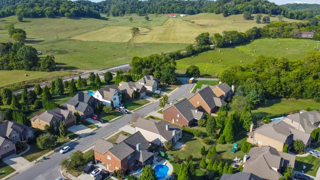 an aerial view of residential houses with outdoor space and river