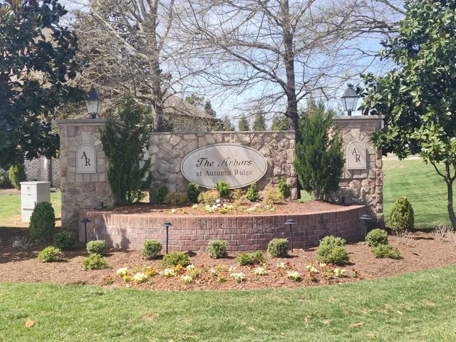 a front view of a house with lots of trees