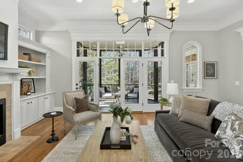 a living room with furniture fireplace and chandelier