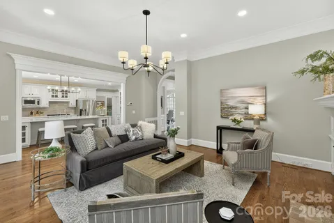 a living room with furniture and a chandelier