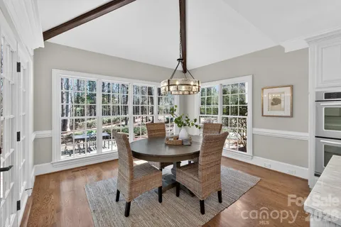 a kitchen with center island table and chairs