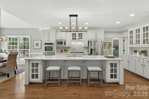 a kitchen with a refrigerator and a stove