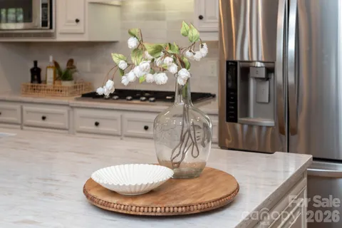 a kitchen with kitchen island a stove cabinets and wooden floor