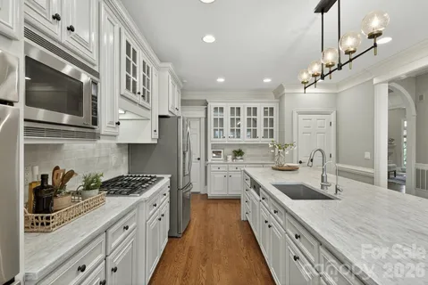 a close view of a stove a microwave and cabinets