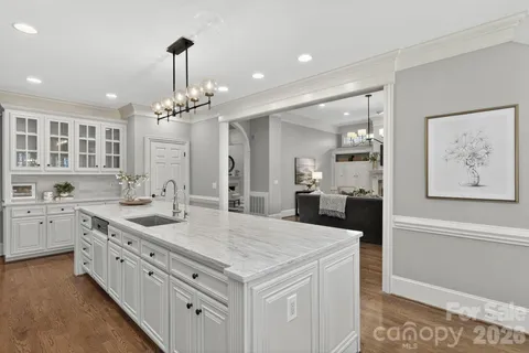 a spacious bedroom with a bed and wooden floor