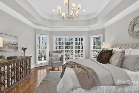 a view of a room with wooden floor cabinet and bathroom