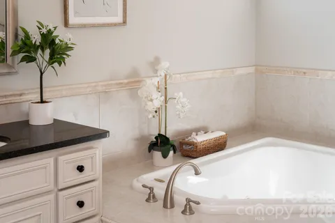 a bathroom with a granite countertop sink mirror and shower