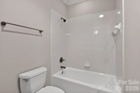 an empty room with windows and ceiling fan