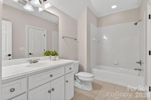 a living room with furniture and white walls