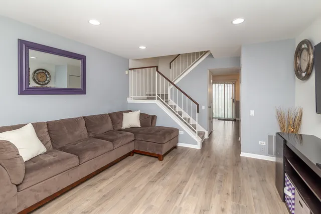 a living room with furniture and a wooden floor