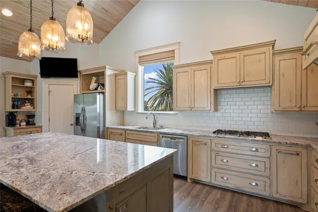 a kitchen with cabinets and chandelier