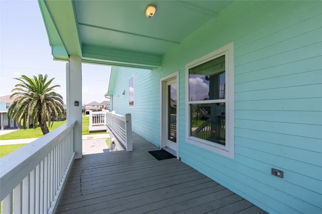 a view of a house with balcony and wooden floor