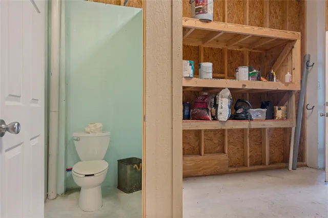 a living room with a baby crib and a wooden floor