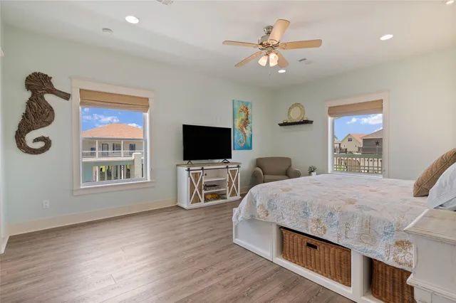 a spacious bedroom with a bed and a flat screen tv