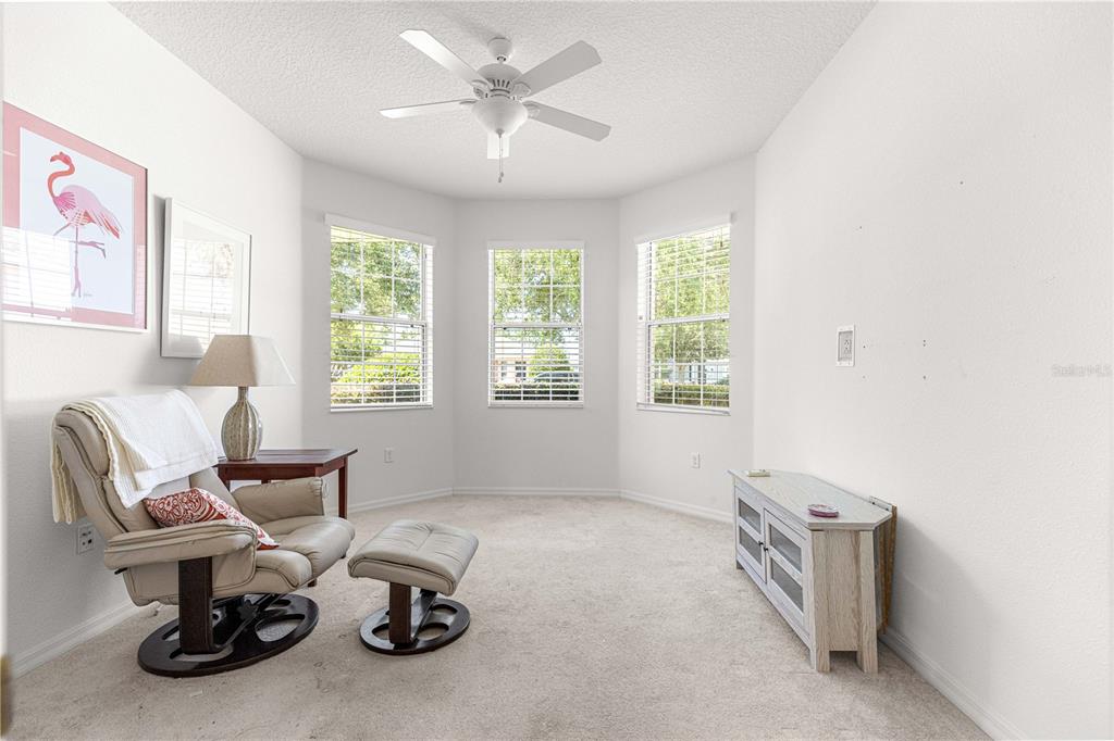 9317 Southwest 94th Loop Ocala, FL 34481 - Photo 27 of 40 a living room with furniture and a large window