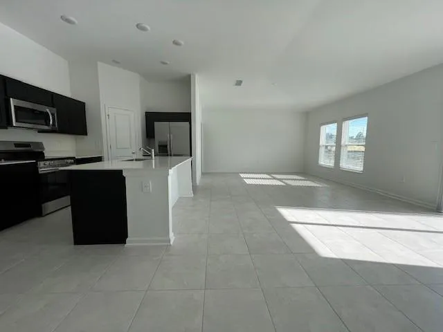a kitchen with stainless steel appliances granite countertop a refrigerator and a stove top oven