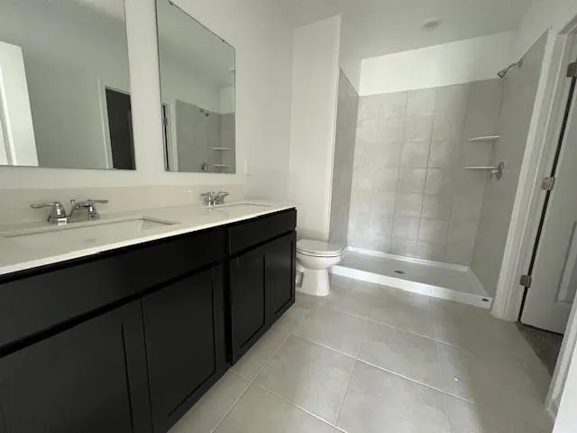 a bathroom with a bathtub a sink a toilet and a mirror