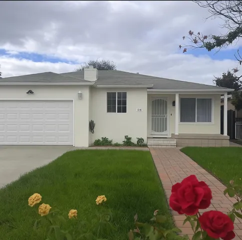 a front view of a house with yard