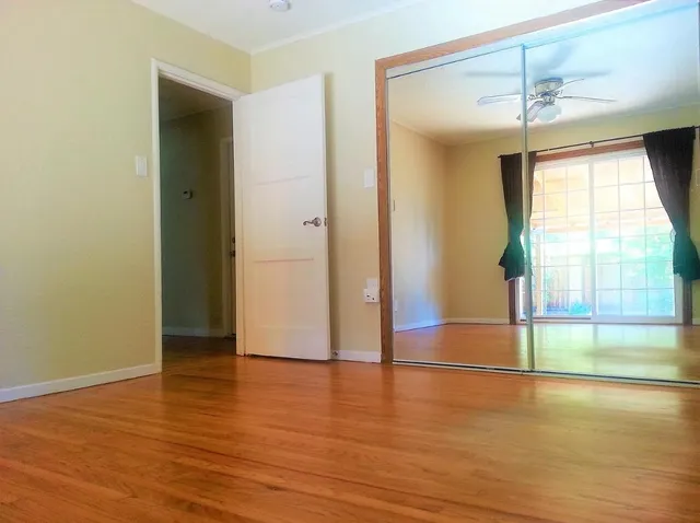 wooden floor in an empty room with a window
