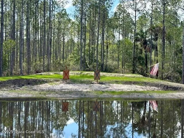 a view of a lake with a house in the background