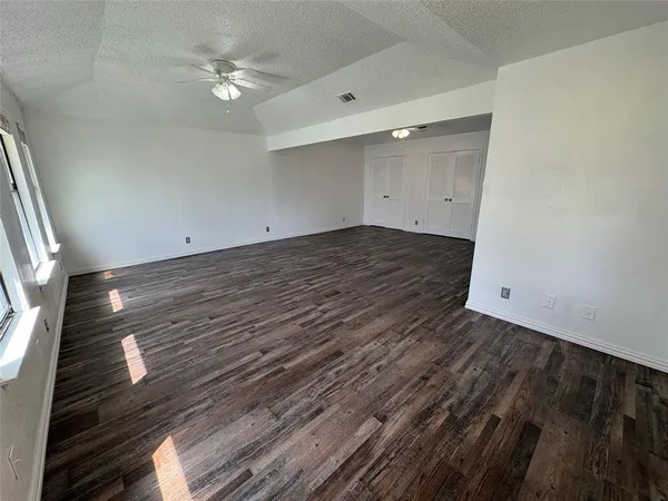 a view of a room with wooden floor