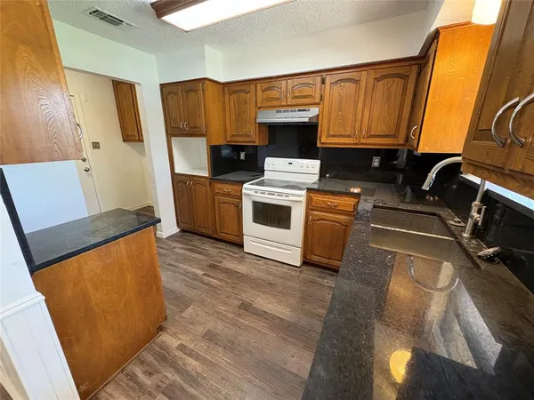 a kitchen with a sink appliances and cabinets